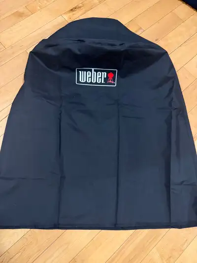 Weber bbq cover Brand New. About 21” across.