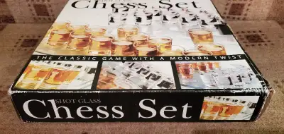 YOU ARE PURCHASING A NEW IN THE BOX A 32 SHOT GLASSES CHESS SET GLASS BOARD GAME IN PERFECT CONDITIO...