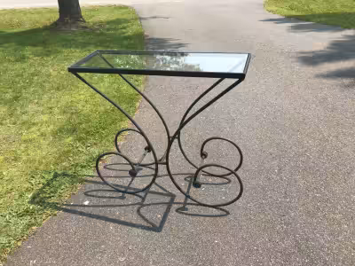 Decorative glass-topped table with wrought- iron legs; length 36", width 12", height 34"