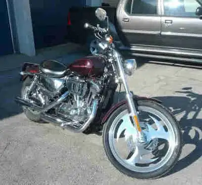 Get ready to turn heads with this stunning 2006 Harley-Davidson Sportster 1200 Custom, featuring a p...