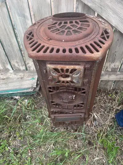 Check out this antique stove, a charming piece of history! Its detailed design and sturdy constructi...