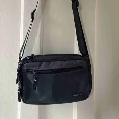 Cross-body bag. Brand: Eddie Bauer. Colour: Steel Gray/Black Trim Many compartments. Zippers strong....