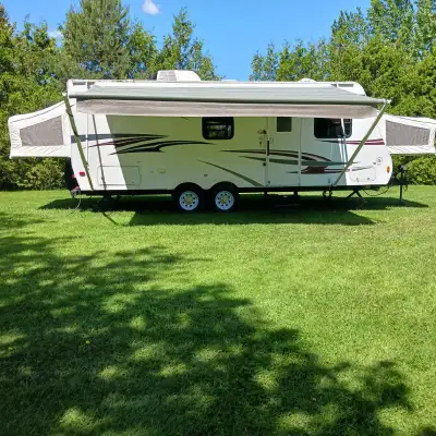 Selling 2012, 23 foot Trail Sport Hybrid Camper Trailer, tandem axle, newer tires. Large pull-out wi...