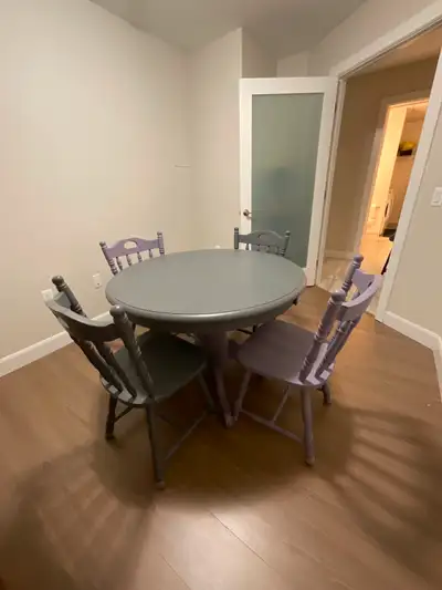 Solid oak table and 4 chairs. Worn, but in great condition. Very solid Table has a built in leaf, so...