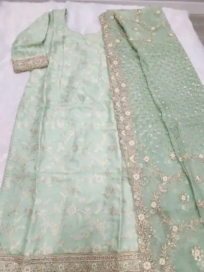 Looking for the perfect outfit for your next wedding or Eid? This stunning mint green Banarasi silk...