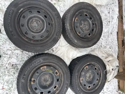 Offering a set of four 225/65R17 Michelin Latitude X-Ice winter tires mounted on steel rims, perfect...