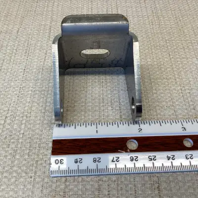 Metal Bracket 90 degree bend 1⅝" x 1⅝" x 1⅝" Sides are tapered Lip on one side 10 gauge stainless st...