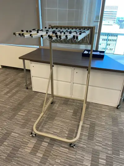 Adjustable height rolling drawing rack, has 12 hangars that can hold multiple pages on each hangar....