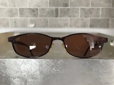 Bronze metal frame with Black PVC temple tips in good condition. Photo-chromatic lenses. Includes or...