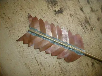 Beautiful antique copper and brass directional arrow, 22 1/4 inches in length, the tail feathers are...