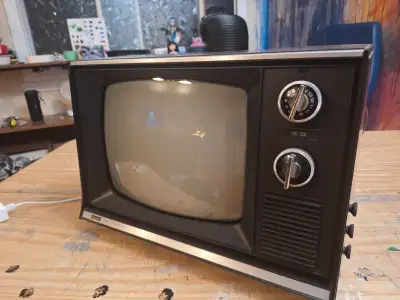 Retro Sears Solid State TV with plastic screen cover.