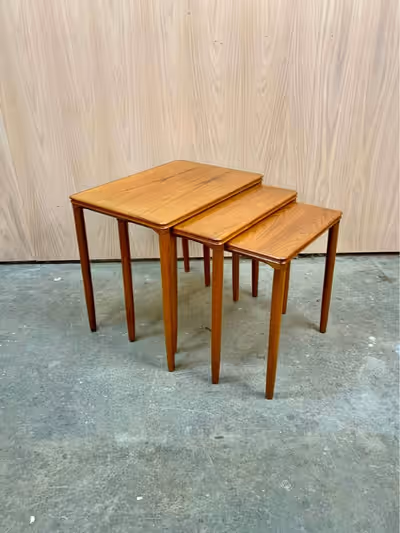 New to our collection is a classic set of teak nesting tables crafted in Denmark during the 1960s. T...