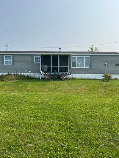 I'm selling a cozy two-bedroom mini home with a warm, inviting atmosphere. This home features an ope...