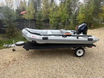 1999 Zebec inflatable boat package with a 2006 Tohatsu 20HP outboard motor and custom trailer. Compl...