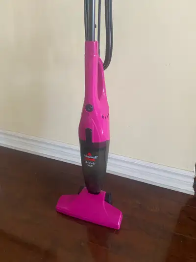 Pink Bissell 3-in-1 vacuum. Lightweight and easy to use. Great for quick cleanups.