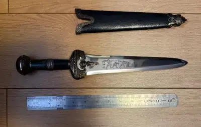 Round pummel and stone like handle. Engraved blade and leather sheath. 14.5"