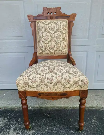 Antique walnut hand carved Eastlake Victorian 19th century parlour chair. Floral pattern fabric is i...