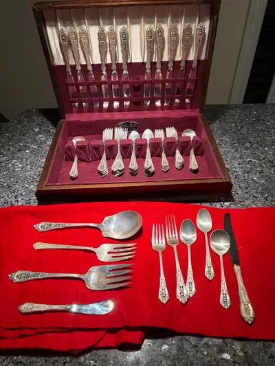 This 76 piece Rose point flatware set from Wallace is Sterling silver has never been used and has be...