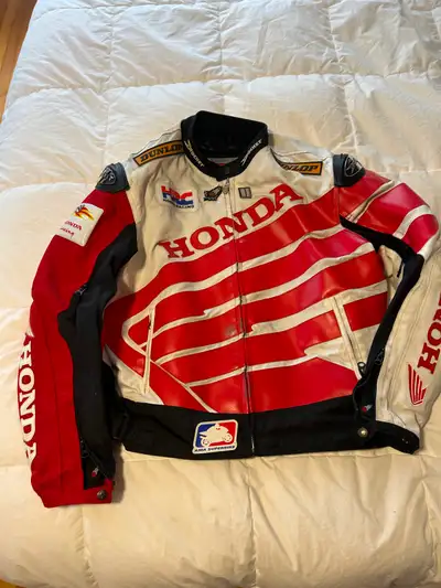 Used racing team style jacket, size L Med weight, side vents, no liner, All zippers work, Slight tea...
