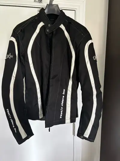 This is a black woman’s size 10 motorcycle jacket designed with white accents and is perfect for any...
