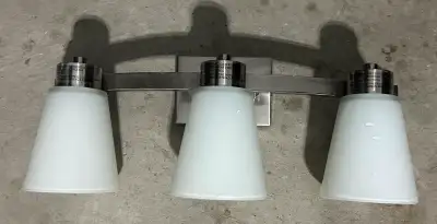 Description VALU+ brushed nickel vanity light gives a renewed shine in your bathroom, no matter its...