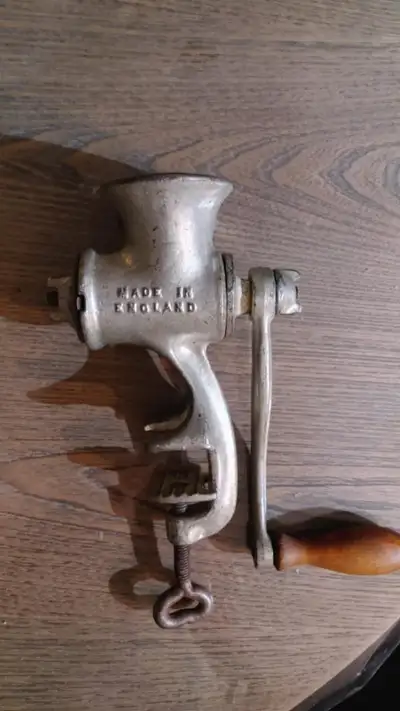 Antique food chopper or meat grinder. It's a collectible and has 2 blades for coarse or fine choppin...