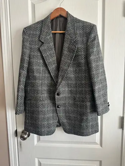 Textured tweed blazer has grey and white weave with subtle teal accents. This jacket has two-button...