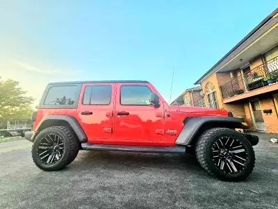 Feast your eyes on this vibrant red 2018 Jeep Wrangler Unlimited, a four-wheel-drive SUV that's read...