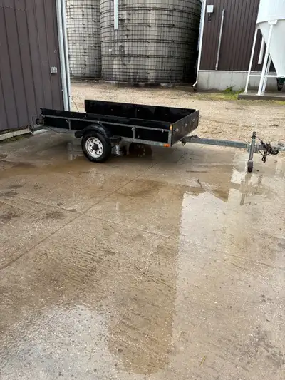 Aluminum frame trailer with wooden sides. 8ft long by 56 inches wide. Comes with ramp and trailer ti...