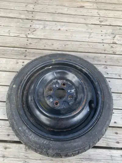 This is a pre-owned space saver spare tire and wheel assembly, perfect for ensuring you are prepared...