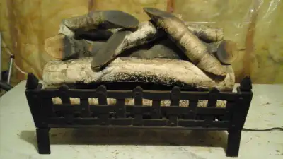 I am selling a vintage fireplace log set. Heavy duty iron grate with illuminating log set in very go...