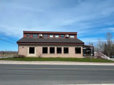 Available for rent is a well-maintained office building featuring multiple windows, a functional lay...