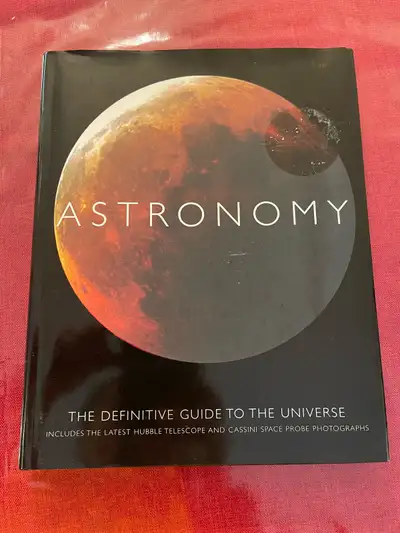 Selling a book titled Astronomy: The Definitive Guide to the Universe It includes the latest Hubble...
