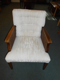 Tan fabric cushion armchair with wicker sides