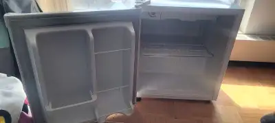 Small roughly 2 foot tall mini fridge. Ice box and small can holder in door. Used but in good shape.