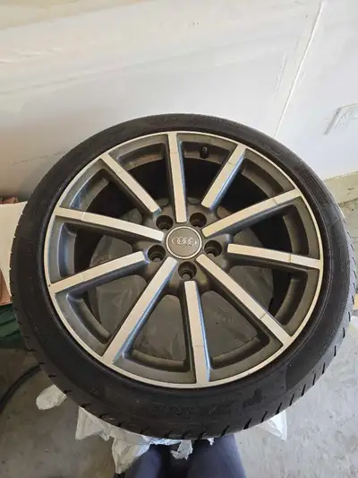 18-inch original Audi rim with a tire, sized at 225/40ZR18 pirelli p zero , The tire and rim are sli...