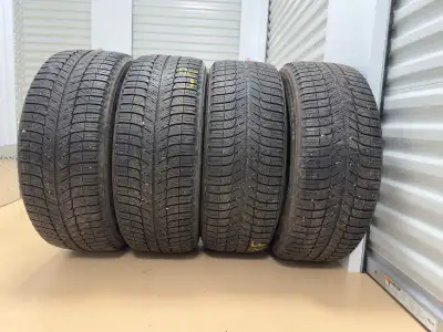 85% of tread Set of 4 Tires with rims 240$ for all Winter tires Michelin X-Ice Size: 235/50 R18 Loca...