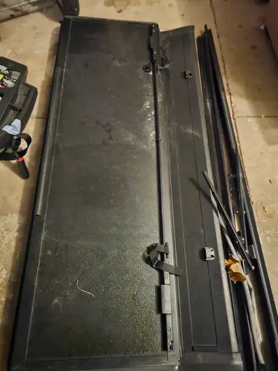 Barely used tonneau cover for a 5' 7" truck bed. Hard top, solid folding cover.