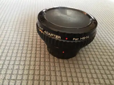 This is a metal lens adapter designed to connect Hasselblad lenses to Nikon HB-NI cameras, proudly m...