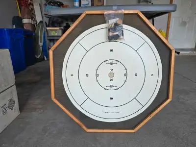 Crokinole board including game pieces. 8-sided board in excellent condition. Fun for all ages. Back...
