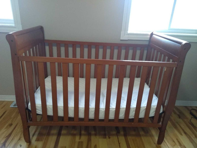 Wooden crib with two plastic coat mattress  in Cribs in Mississauga / Peel Region