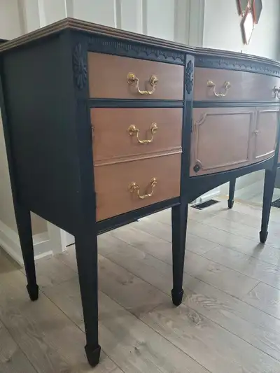This refurbished black and wood sideboard offers a blend of classic elegance and practical storage,...