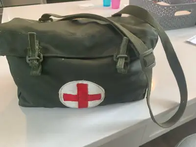 This authentic 1960s first aid bag features a durable canvas exterior with iconic retro red cross br...