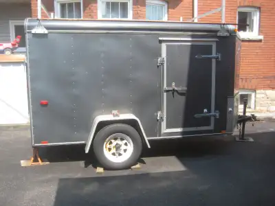 6' x 12' international 1 trailer with ramp type tailgate and side door. interior is plywood lined wi...