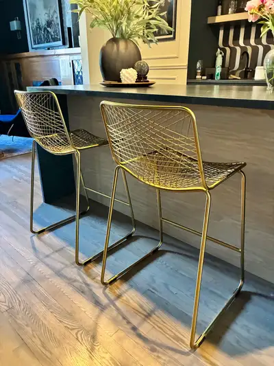These stylish, pre-owned CB2 gold metal wire bar chairs will instantly elevate the look of your home...