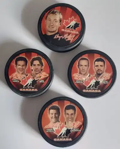 Lot of four pucks from the 2002 McDonald's Canada Olympic set. Front sides - all nice, Sakic/Kariya...