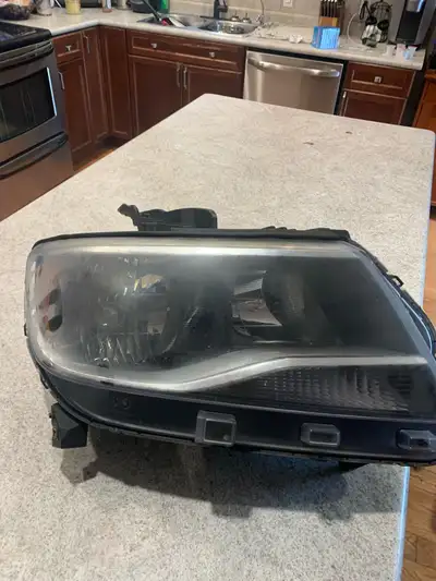 I'm selling a used headlight from a Chevrolet Colorado, specifically designed for models between 201...