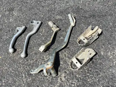 Stock OEM parts taken off a 2015 CRF150F Front Brake and clutch levers $25 ea Foot pegs $20 Rear bra...