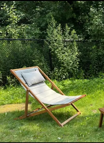 Modern outdoor folding lounge chair made from solid wood with comfortable fabric seat. Beautiful min...