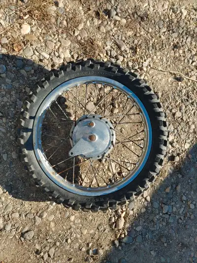 Rear wheel from an old dirtbike. I do not know what brand it is from but it looks like something fro...